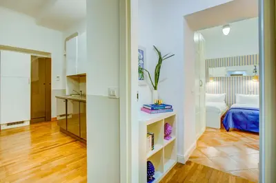 a small bedroom with a bed and a mirror at Colosseo Families and Groups 2BDR Home and More in Rome