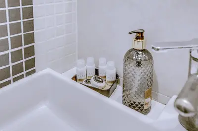 a bathroom with a toilet and a bottle of soap at Colosseo Families and Groups 2BDR Home and More in Rome