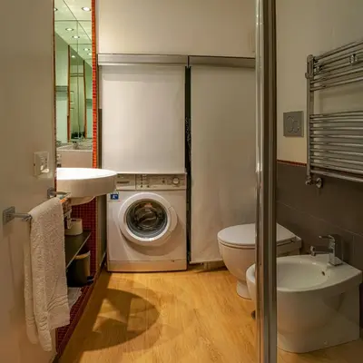 a bathroom with a washing machine and a washer at Palestro Apartments in Rome