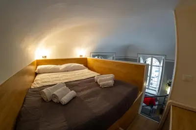a bedroom with a bed with two towels on it at Palestro Apartments in Rome