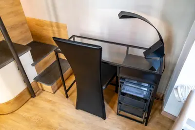 a desk with a black lamp on top of it at Palestro Apartments in Rome