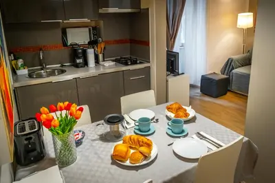 a kitchen with a table with bread and flowers on it at Palestro Apartments in Rome