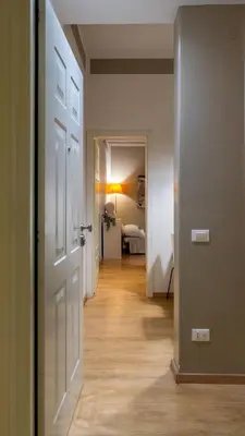 a hallway with an open door and a bedroom at Palestro Apartments in Rome