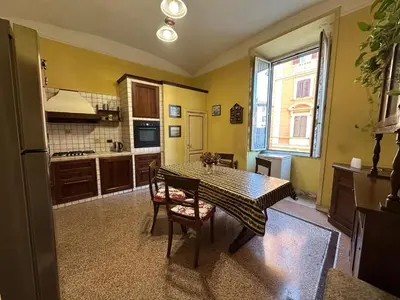 a kitchen with a table and chairs in a room at L'Angolo di Roma in Rome