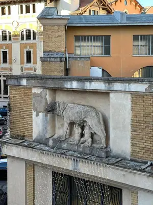 a statue of a dog on the side of a building at L'Angolo di Roma in Rome
