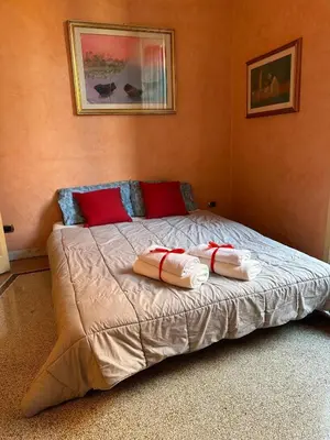a bedroom with a bed with two pillows on it at L'Angolo di Roma in Rome