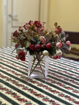 a vase with a bouquet of flowers on a table at L'Angolo di Roma in Rome