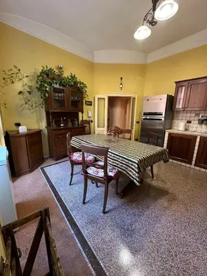 a kitchen with a table and chairs in a room at L'Angolo di Roma in Rome