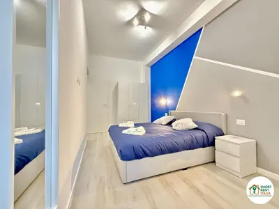 a bedroom with a bed and a large window at Re di Roma - Colosseo House in Rome