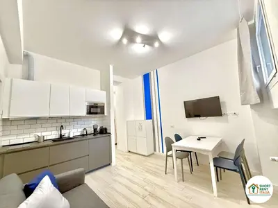 a kitchen and dining room with a table and chairs at Re di Roma - Colosseo House in Rome