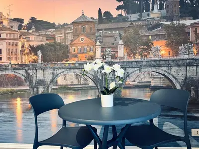 a table with a vase of flowers on top of a bridge at Roma Elena in Rome