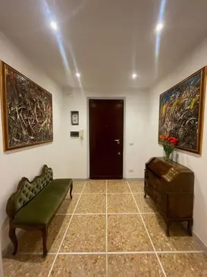 a living room with a couch and paintings on the wall at Vatican Apartment Cipro in Rome