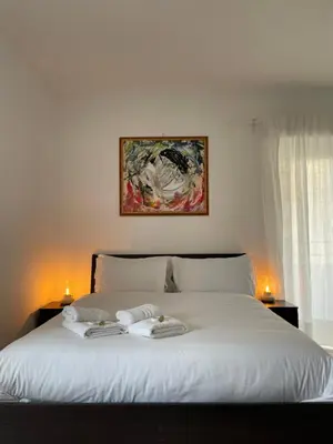 a bedroom with a white bed with two towels on it at Vatican Apartment Cipro in Rome