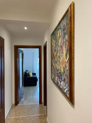 a hallway with a painting hanging on a wall at Vatican Apartment Cipro in Rome