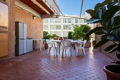 a patio with a table and chairs on a balcony at La terrazza di Maria Pia in Rome