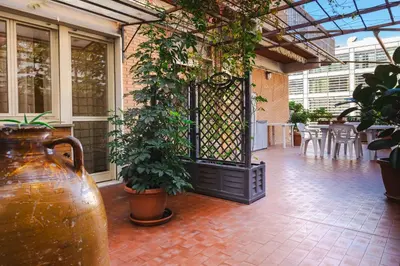 a patio with plants and a gate in a building at La terrazza di Maria Pia in Rome