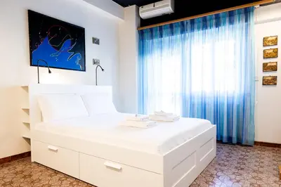 a white bed in a room with a window at La terrazza di Maria Pia in Rome