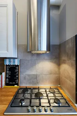 a kitchen with a stove top with a hood at Art Gallery House, San Giovanni, Roma Centro - Wifi AC Smart TV in Rome