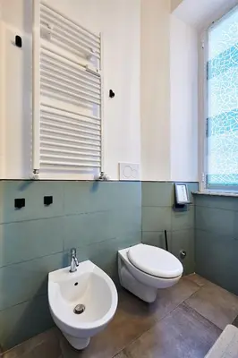 a bathroom with a toilet and a sink at Art Gallery House, San Giovanni, Roma Centro - Wifi AC Smart TV in Rome