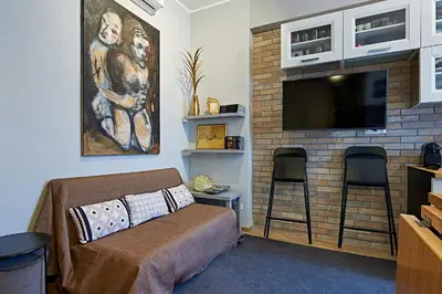 a living room with a couch and a fireplace with a television at Art Gallery House, San Giovanni, Roma Centro - Wifi AC Smart TV in Rome