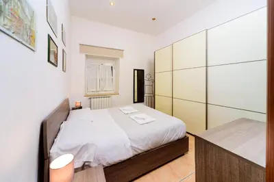 a small bedroom with a bed and a desk at Locazione turistica Via Caltanissetta in Rome