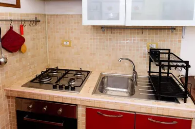 a kitchen with a sink and a stove at Locazione turistica Via Caltanissetta in Rome