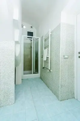 a bathroom with a walk in shower and a glass door at Locazione turistica Via Caltanissetta in Rome