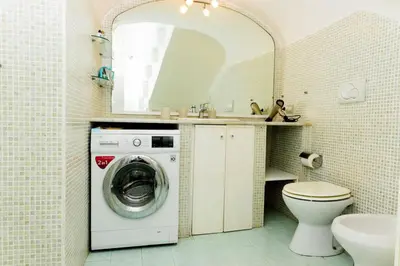 a bathroom with a washing machine and a sink at Locazione turistica Via Caltanissetta in Rome