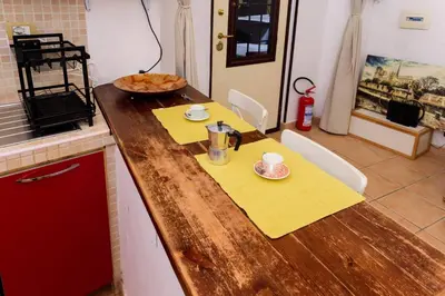a kitchen with a wooden counter top with a coffee maker on it at Locazione turistica Via Caltanissetta in Rome