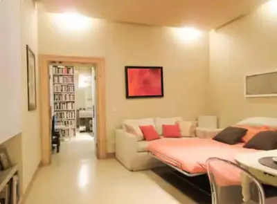 a living room with a couch and a bed in it at Carrozze Suite in Rome