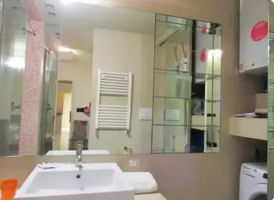 a bathroom with a sink and a mirror at Carrozze Suite in Rome