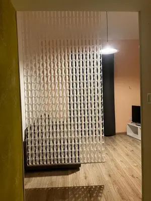 a room with a large glass wall with a wooden floor at CasaPigneto34 in Rome