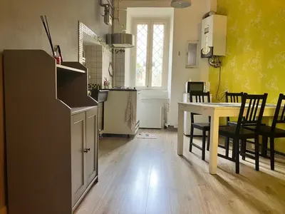 a kitchen and dining room with a table and chairs at CasaPigneto34 in Rome