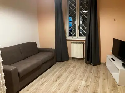 a living room with a couch and a television at CasaPigneto34 in Rome