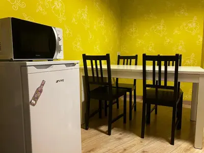 a kitchen with a table with chairs and a microwave at CasaPigneto34 in Rome