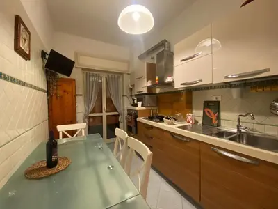 a kitchen with a green table and a sink at La Casa oltre il Parco in Rome
