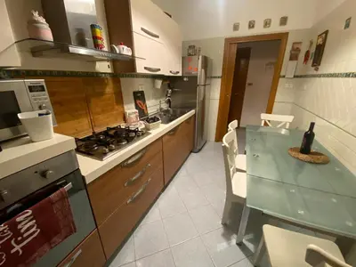 a kitchen with a counter and a stove top oven at La Casa oltre il Parco in Rome