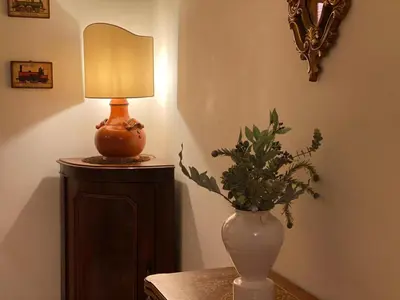 a lamp and a vase with a plant on a table at La Casa oltre il Parco in Rome