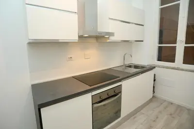 a kitchen with white cabinets and a sink at Prestige Crescenzio in Rome