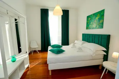 a bedroom with a bed with green pillows on it at Prestige Crescenzio in Rome