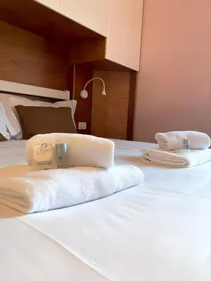 two towels sitting on top of a bed at Gregory Retreat in Rome