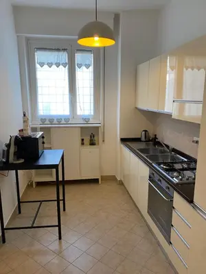 a kitchen with a table and a stove top oven at Gregory Retreat in Rome