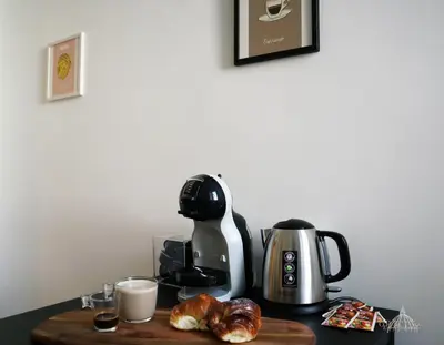 a coffee maker on a table with croissants and a coffee pot at Gregory Retreat in Rome
