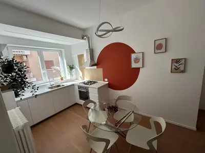 a kitchen with a glass table and chairs in a room at Momenti di serenità a Roma in Rome