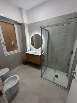a bathroom with a shower and a toilet and a sink at Momenti di serenità a Roma in Rome