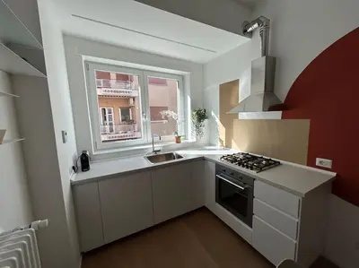 a kitchen with a stove and a sink and a window at Momenti di serenità a Roma in Rome