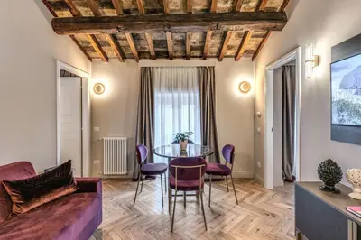 a living room with a table and chairs at Palazzo Ottavia - La Maison D'art Collection in Rome