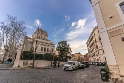 a building on a street with cars parked in front of it at Palazzo Ottavia - La Maison D'art Collection in Rome