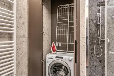 a washing machine in a bathroom with a shower at Palazzo Ottavia - La Maison D'art Collection in Rome