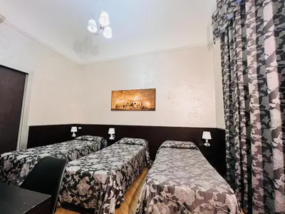 a hotel room with three beds and a curtain at Funny place in Rome